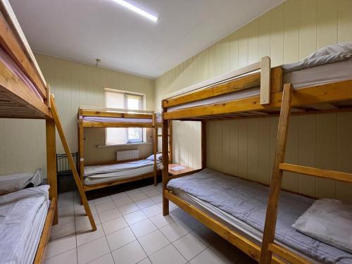 a dorm room with three bunk beds in it at Sun in Khmelnytskyi