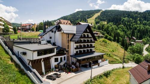 an aerial view of a building in the mountains at Hotel Roman Maramures - Ski & Spa Resort in Statiunea Borsa
