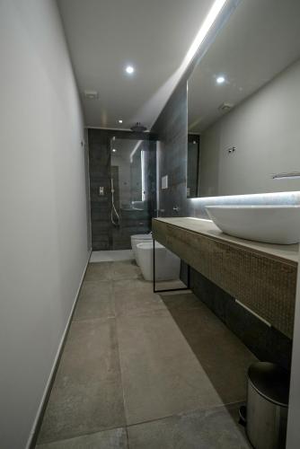 a large bathroom with two sinks and a shower at Domus Smeralda in Porto Cervo