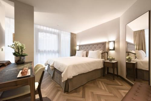 Ένα ή περισσότερα κρεβάτια σε δωμάτιο στο Hotel Astoria