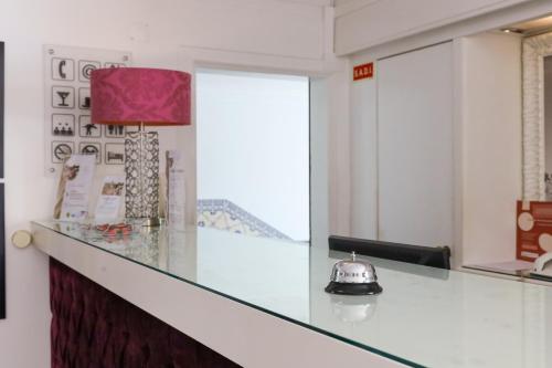 a kitchen with a counter with a tea kettle on it at Josefa D`Obidos Hotel in Óbidos