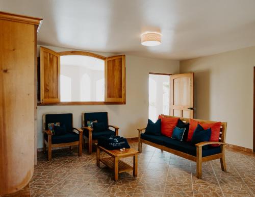 a living room with two chairs and a couch at Wiona of Villa Paraiso / Beachfront Villa & Pool in Big Creek