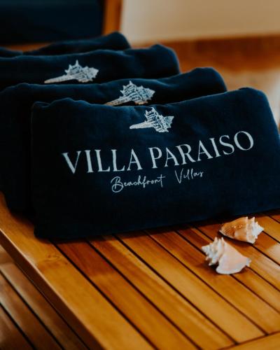 a group of blue towels sitting on top of a wooden table at Wiona of Villa Paraiso / Beachfront Villa & Pool in Big Creek