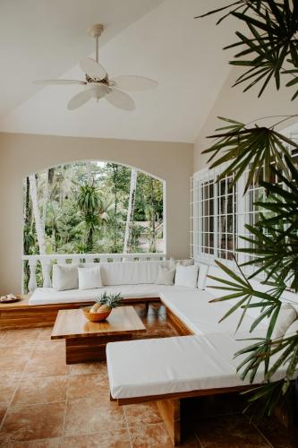 a living room with white furniture and a large window at Wiona of Villa Paraiso / Beachfront Villa & Pool in Big Creek