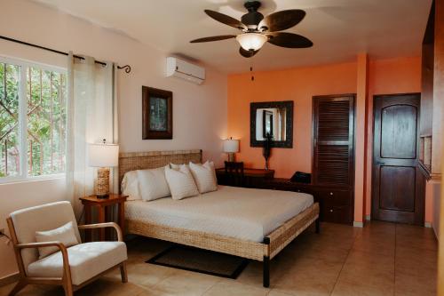a bedroom with a bed and a ceiling fan at Wiona of Villa Paraiso / Beachfront Villa & Pool in Big Creek