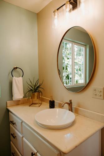 a bathroom with a sink and a mirror at Wiona of Villa Paraiso / Beachfront Villa & Pool in Big Creek