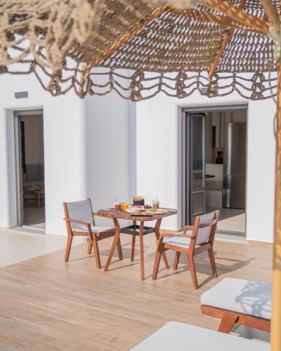 a dining room with a table and chairs at Venus Sunrise Suites & Villas in Vourvoulos