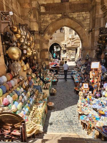 a market with a person walking in the middle of it at Crystal pyramid inn in Cairo