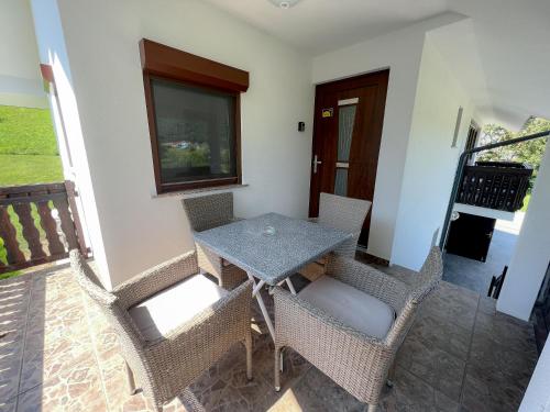 a table and chairs in a room with a balcony at Apartments Sole in Podčetrtek