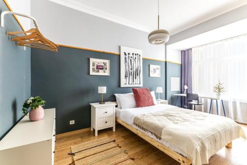 a bedroom with a bed and a blue wall at 2BR - 1 min Taksim Sq İstiklal Avenue in Beyoglu in Istanbul