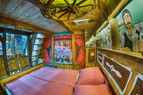 a train room with a bed and a painting on the wall at Hotel Kocourkov in Hlinsko