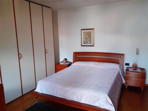 a bedroom with a bed and two night stands at Camera con vista in Calalzo