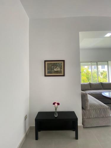 a living room with a couch and a table at Appartement de luxe en bord de mer à Skhirat Plage in Skhirat