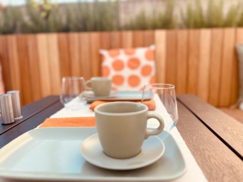 a table with a coffee cup and glasses on it at B&B 366 in Vrboska