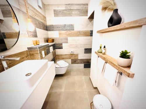 a bathroom with a white sink and a toilet at B&B 366 in Vrboska