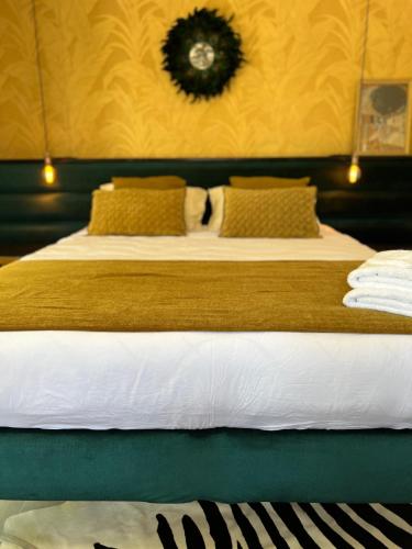 a bedroom with two beds and a clock on the wall at B&B 366 in Vrboska