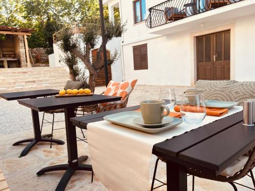 a table with two chairs and two tables with food on it at B&B 366 in Vrboska