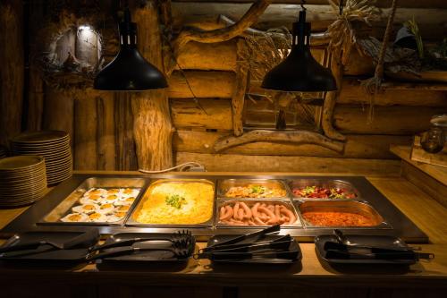 a buffet with many trays of food on a table at Hotel Kocourkov in Hlinsko