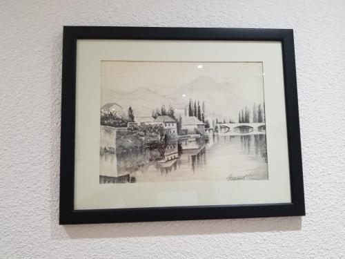 a framed drawing of a painting of a city at Apartmani Vasković in Trebinje