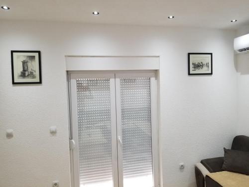 a living room with a sliding glass door at Apartmani Vasković in Trebinje