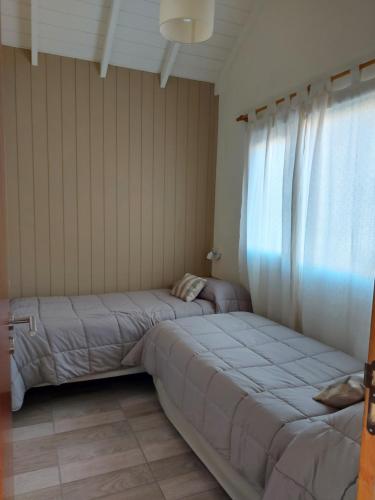 Ένα ή περισσότερα κρεβάτια σε δωμάτιο στο Cabañas Los Manzanos