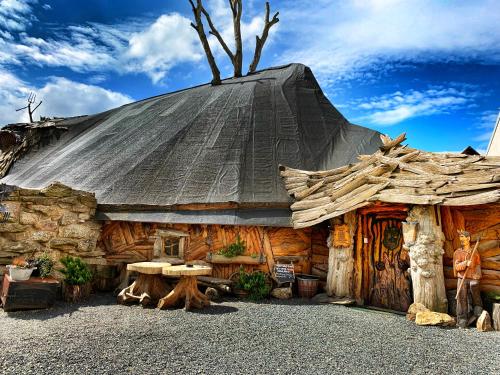 a log cabin with a black roof at Hotel Kocourkov in Hlinsko