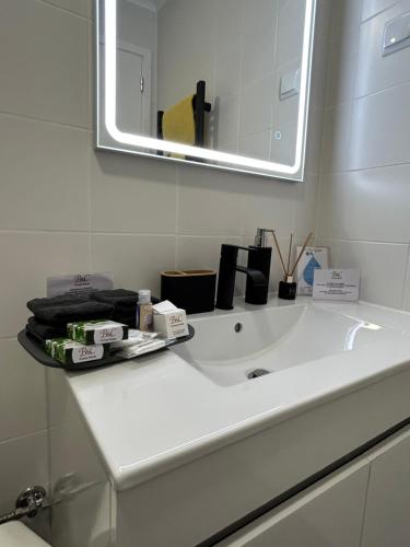a bathroom with a white sink and a mirror at B&C Furnas House in Furnas
