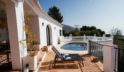 a villa with a swimming pool on a patio at Hearts & Home in Mijas