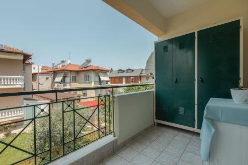 a balcony with green lockers and a view of a city at Tommy's Family Apartment in Katerini
