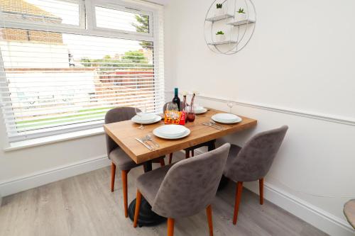 a dining room with a table and chairs and a window at Seafront House with balcony in Eastbourne