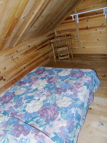 a bedroom with a bed and a chair in a attic at Montaña Verde in Rivas