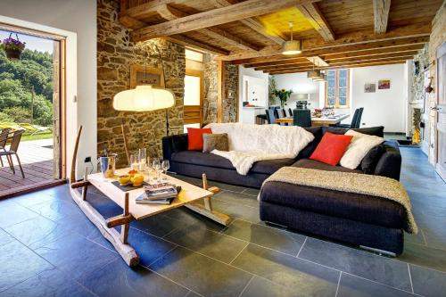 een woonkamer met een bank en een tafel bij Chalet Ladroit - OVO Network in Les Clefs