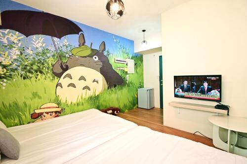 a bedroom with a mural of a cow with an umbrella at Taichung FJ Victoria in Taichung