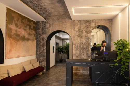 a man sitting at a desk in a lobby at Hotel Regno in Rome
