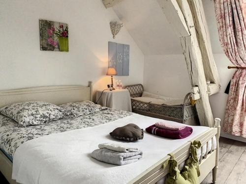 1 dormitorio con 1 cama con toallas en Maison du bonheur en Pouilly-en-Auxois