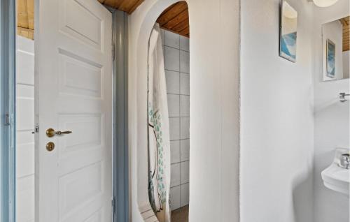 a bathroom with a white door and a sink at Nice Apartment In Bindslev With Wifi in Bindslev