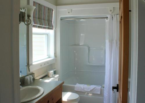 a bathroom with a sink and a toilet and a shower at Rodd Crowbush Golf & Beach Resort in Morell