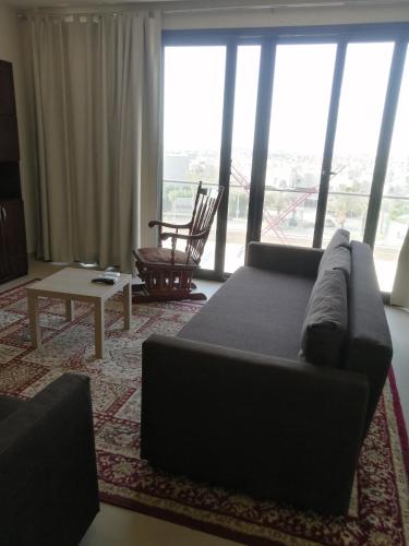 a living room with a couch and a table at Premium Sea View Chalet in Azha Ain Sokhna in Ain Sokhna