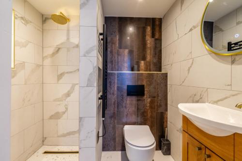 a bathroom with a shower and a toilet and a sink at 34 Coney Street in York