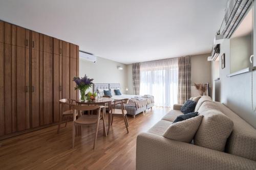 a living room with a couch and a table at Palanga Visit Apartments and SPA in Palanga