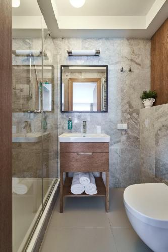 a bathroom with a sink and a shower at Palanga Visit Apartments and SPA in Palanga