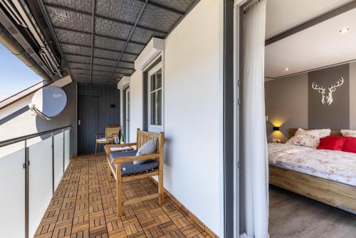 a bedroom with a bed and a balcony at Basislager in Albstadt