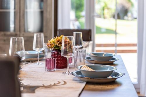 a table with plates and wine glasses on it at Basislager in Albstadt