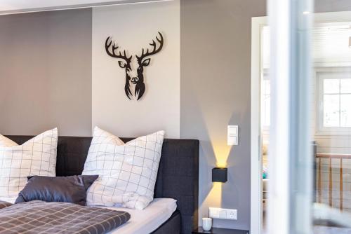 a bedroom with a bed with a deer head on the wall at Basislager in Albstadt