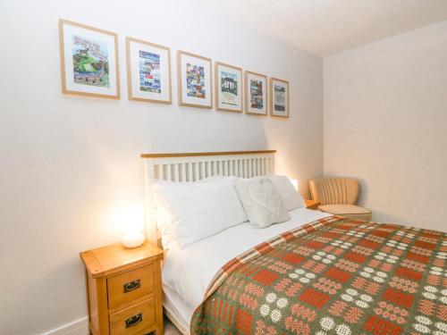 a bedroom with a bed and a table with a lamp at Bryn Tirion in Holyhead