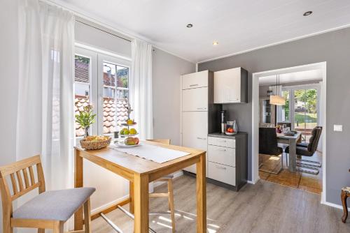 a kitchen with a wooden table and a dining room at Basislager in Albstadt