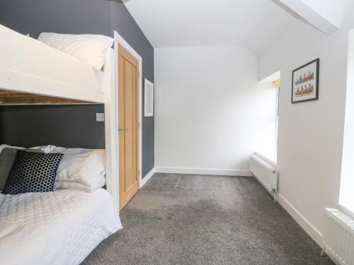 a bedroom with a bunk bed in a room at Bryn Tirion in Holyhead