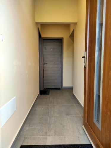 a hallway with a door and a tile floor at Villa Grácia in Badacsonytomaj