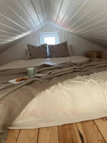 a large bed in a room with a ceiling at Oak Heart, Lucavsalas namiņš in Rīga
