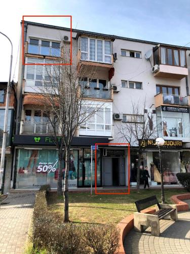 a building with a bench in front of a building at Blerta's apartment in Prizren